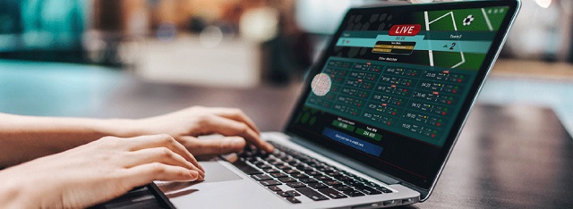 Trader sportif analysant les cotes et données du sport business